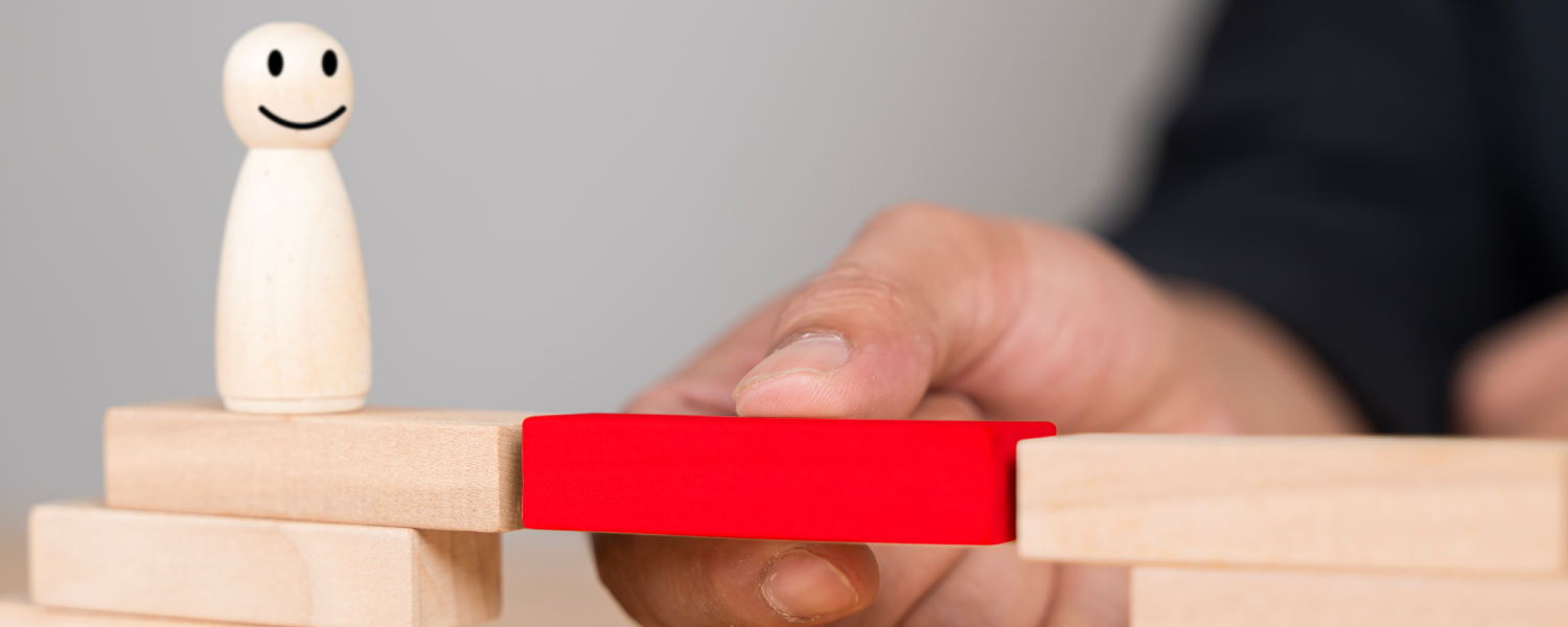 Bridge made out of wooden blocks with a red brick connecting safety culture and driver experience.